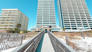 A modern hotel with a central atrium, multiple floors, and a beachside location.