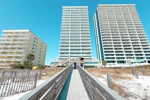 A modern hotel with a central atrium, multiple floors, and a beachside location. - The Colonnades 1803 | Walk to HangOut! | Beachfront, Pool, Sauna, Fitness Center | Beach Getaways (Gulf Shores)