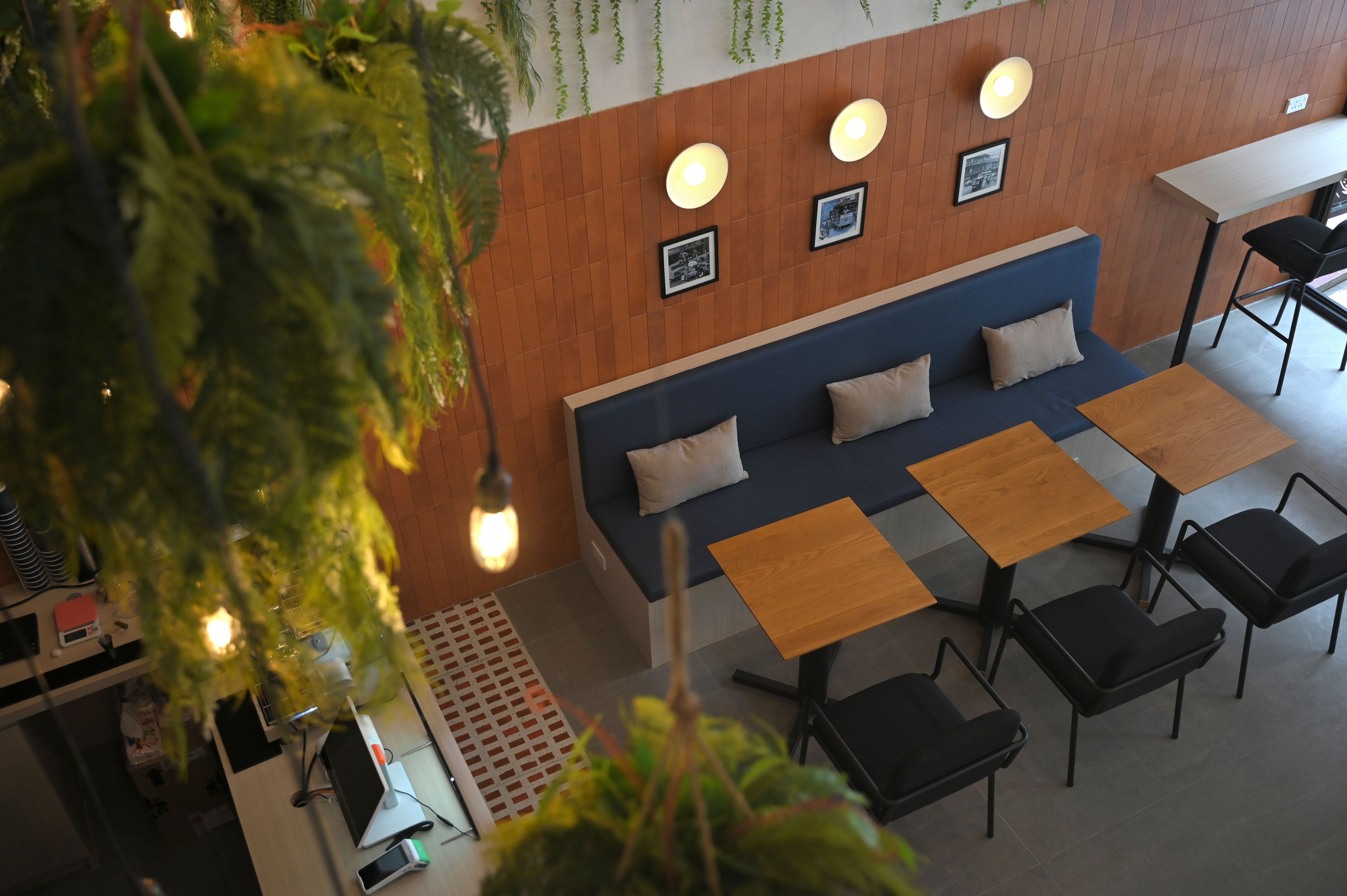 A modern interior with a sofa, tables, and chairs arranged around a central seating area.