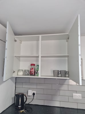 A kitchen with a white cabinet, a kettle, and a coffee maker on the counter. - City Centre, En-Suit Double Rm-3, City View Place  (Cambridge)