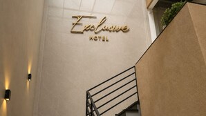 A hotel sign with the name 'Exclusive Hotel' on a wall. - Exclusive Hotel (Campos Sales)