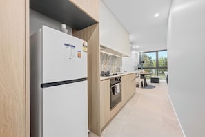 Eine moderne Küche mit Einbaukühlschrank, Backofen und Spüle.