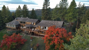 A large, multi-story house with a spacious deck and multiple rooms. - Eagle's Bluff Estate on Flathead Lake near Glacier National Park (Polson)