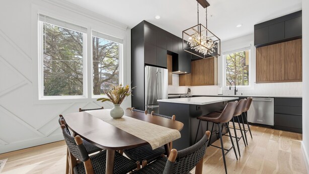 A modern kitchen with a dining area, large windows, and a chandelier. - Steps to Mercedes Benz, Arena, GWCC, Rooftop view (Atlanta)