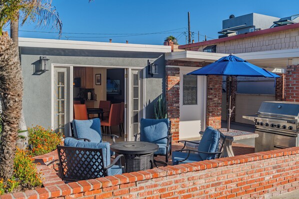 An outdoor patio with seating, a grill, and a view of the backyard. - Strand N Sea • Beach • Hot Tub • Pet Friendly • Channel Islands Harbor (Oxnard)