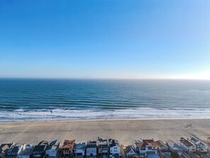 A coastal residential area with houses along the beach, a clear sky, and the ocean. - Strand N Sea • Beach • Hot Tub • Pet Friendly • Channel Islands Harbor (Oxnard)