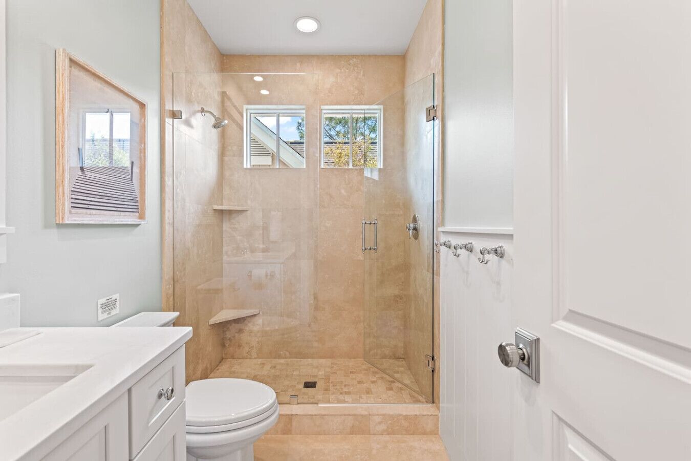 A bathroom with a shower, toilet, and sink.