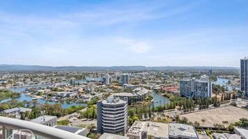 A cityscape with a river, buildings, and a clear sky.