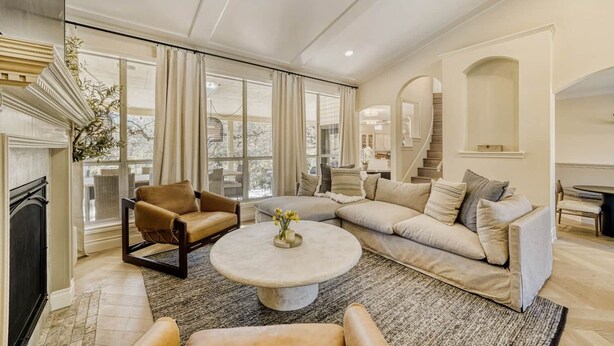 A spacious living room with a fireplace, large windows, a staircase, and a cozy seating area. - LuxuryLake Austin Retreat: Game Room + Fire Pit, Minutes to Downtown (Austin)