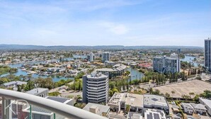 A cityscape with a river, buildings, and a clear sky. - Skyline Hideaway Studio (Gold Coast)
