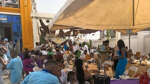 A crowded outdoor event with tables and chairs under a large canopy. - Casa de royal guest house (Kasoa)