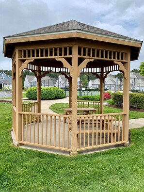 A wooden gazebo with a roof, surrounded by a lawn and a pathway. - XL Resort Beach Home with Pools, Gym, Tennis (Berlin)