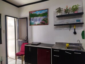 Private kitchen - 1_Las Asturias Charming Condo Just Steps from Enchanted Kingdom (CITY OF SANTA ROSA)