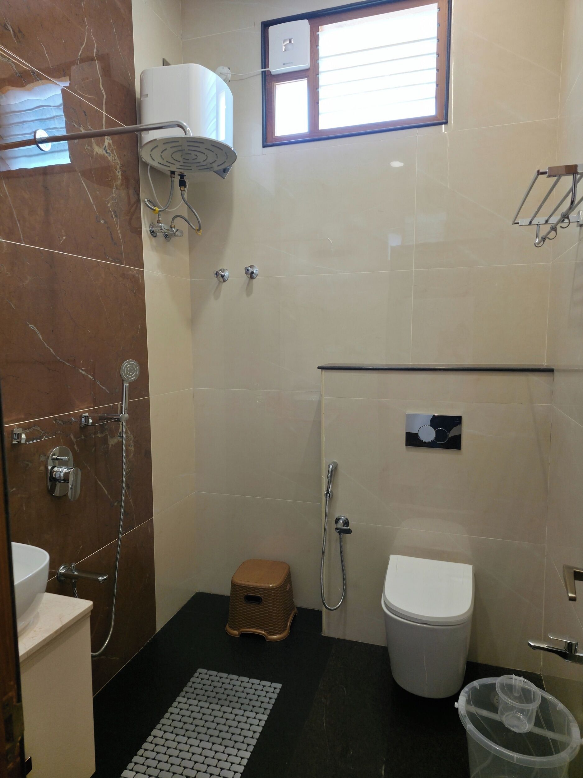A bathroom with a shower, toilet, and sink.