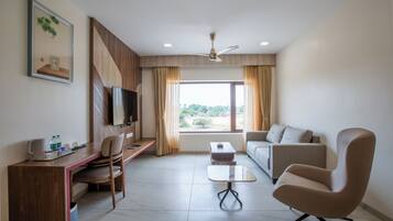 Premium Suite | Living area | 32-inch flat-screen TV with cable channels