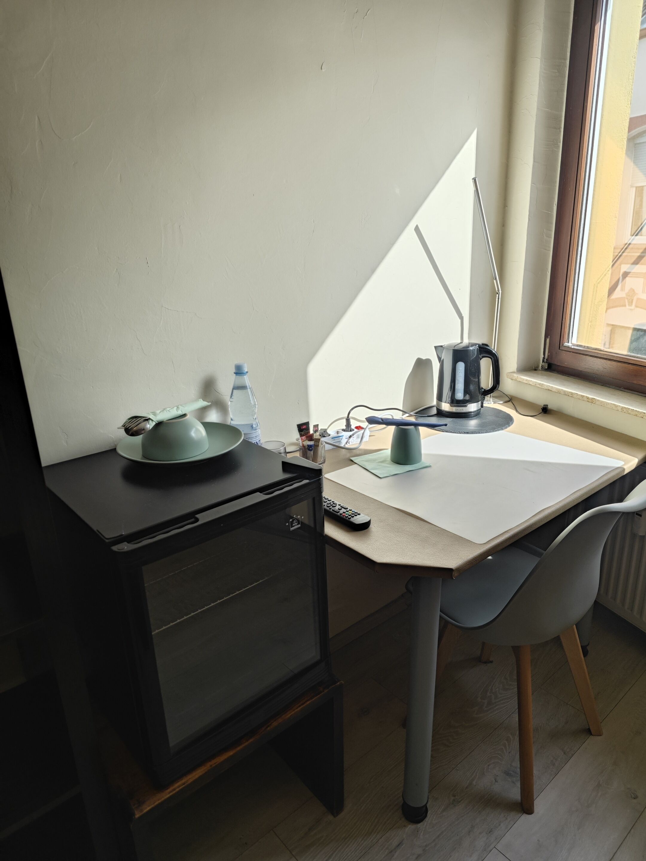 A compact workspace with a desk, chair, and a window with a view.