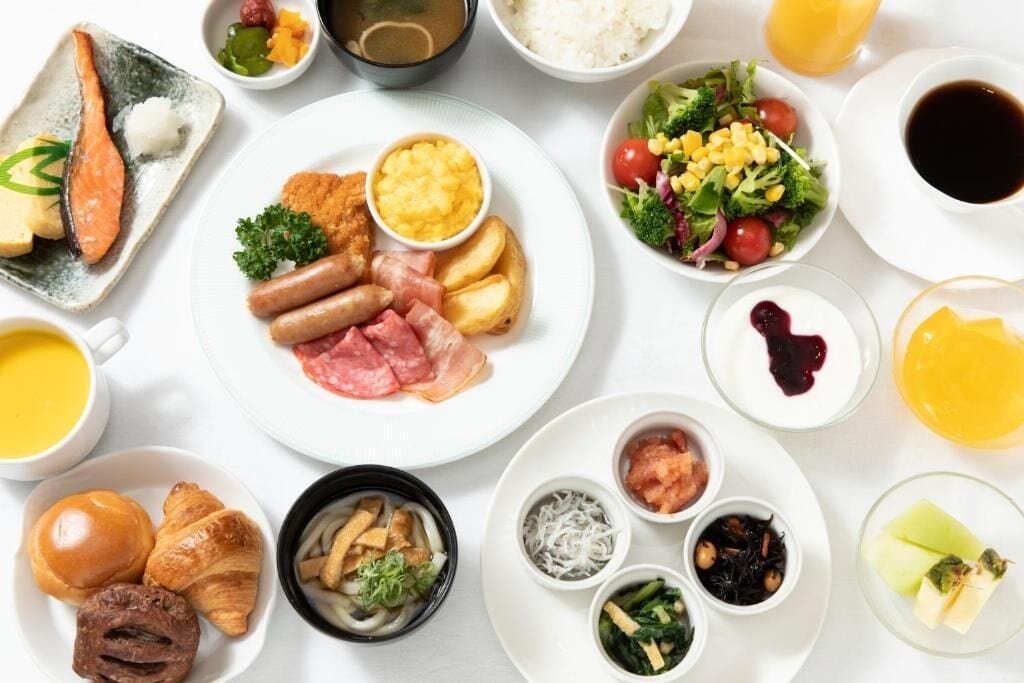 A variety of breakfast dishes including salmon, sausages, and eggs.