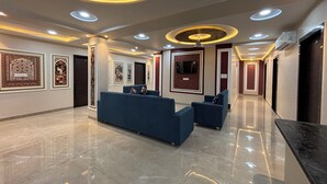 A modern lobby with a reception desk, seating area, and artwork on the walls. - Hotel Shri Ram Legacy (Jodhpur)