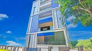 A multi-story building with a sign reading 'Townhouse & Company Services.' - Blissful Stays at Dwarakanagar Near Gurudwara (Visakhapatnam)