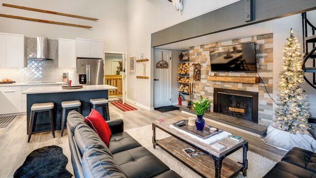 A modern living room with a fireplace, a sofa, and a coffee table. - 3 Mi to Keystone Resort: Updated Condo w/ Balcony! (Keystone)
