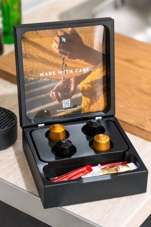 A black box with a QR code, two golden knobs, and a red packet on a countertop. - D-Suites – Aristotelous Square Studio, Thessaloniki Centre (Thessaloniki)