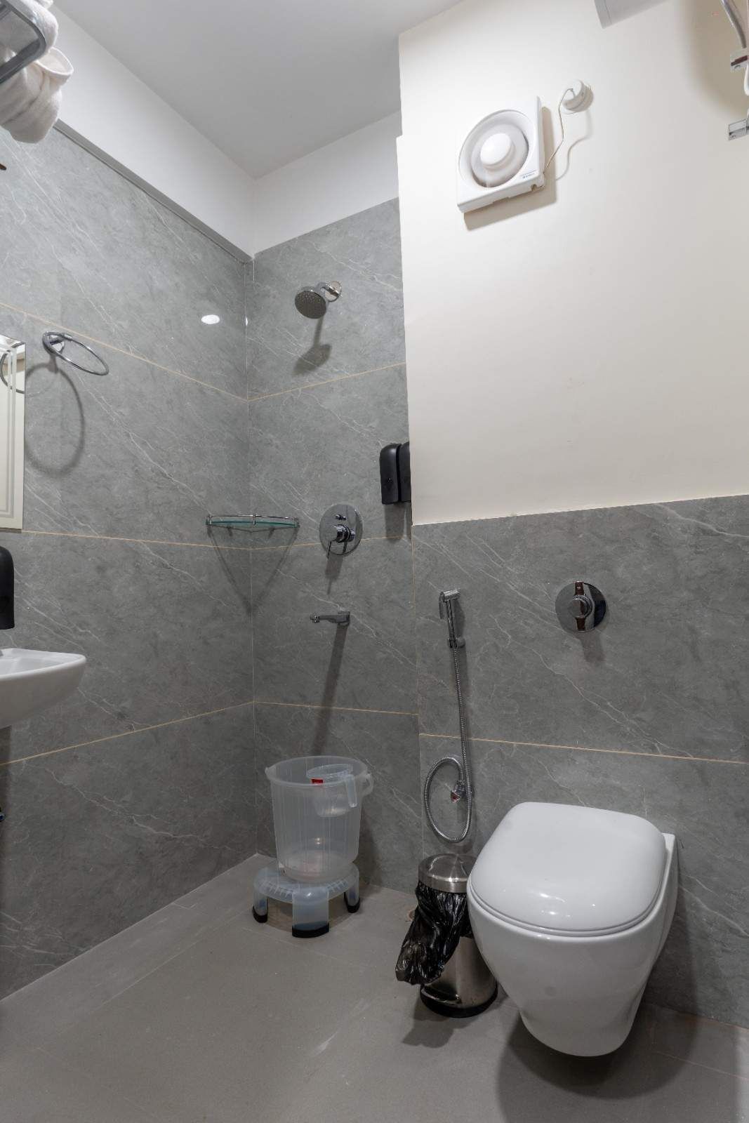 A modern bathroom with a toilet, bidet, and shower.