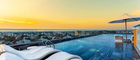 Outdoor pool, open 6:00 AM to 10:00 PM, pool umbrellas, pool loungers