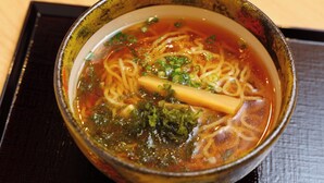 A bowl of ramen with noodles, broth, and toppings.