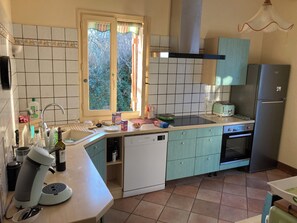 A kitchen with a dishwasher, a toaster, and a refrigerator.