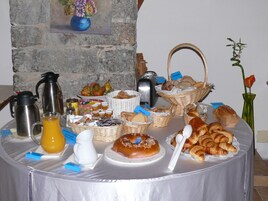 Um buffet de café da manhã com diversos alimentos e bebidas.