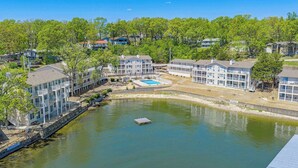 A waterfront hotel with multiple-story buildings, a swimming pool, and a dock. - Lake Mode Lakefront Balcony (Osage Beach)