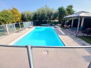 A rectangular swimming pool with a clear blue water, surrounded by a white fence. - Villa in Grasse with swimming pool (Grasse)