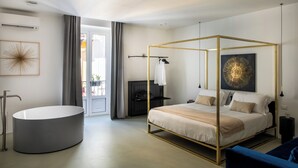 A modern bedroom with a four-poster bed, a round bathtub, and a large window. - Palazzo Achates (Palermo)