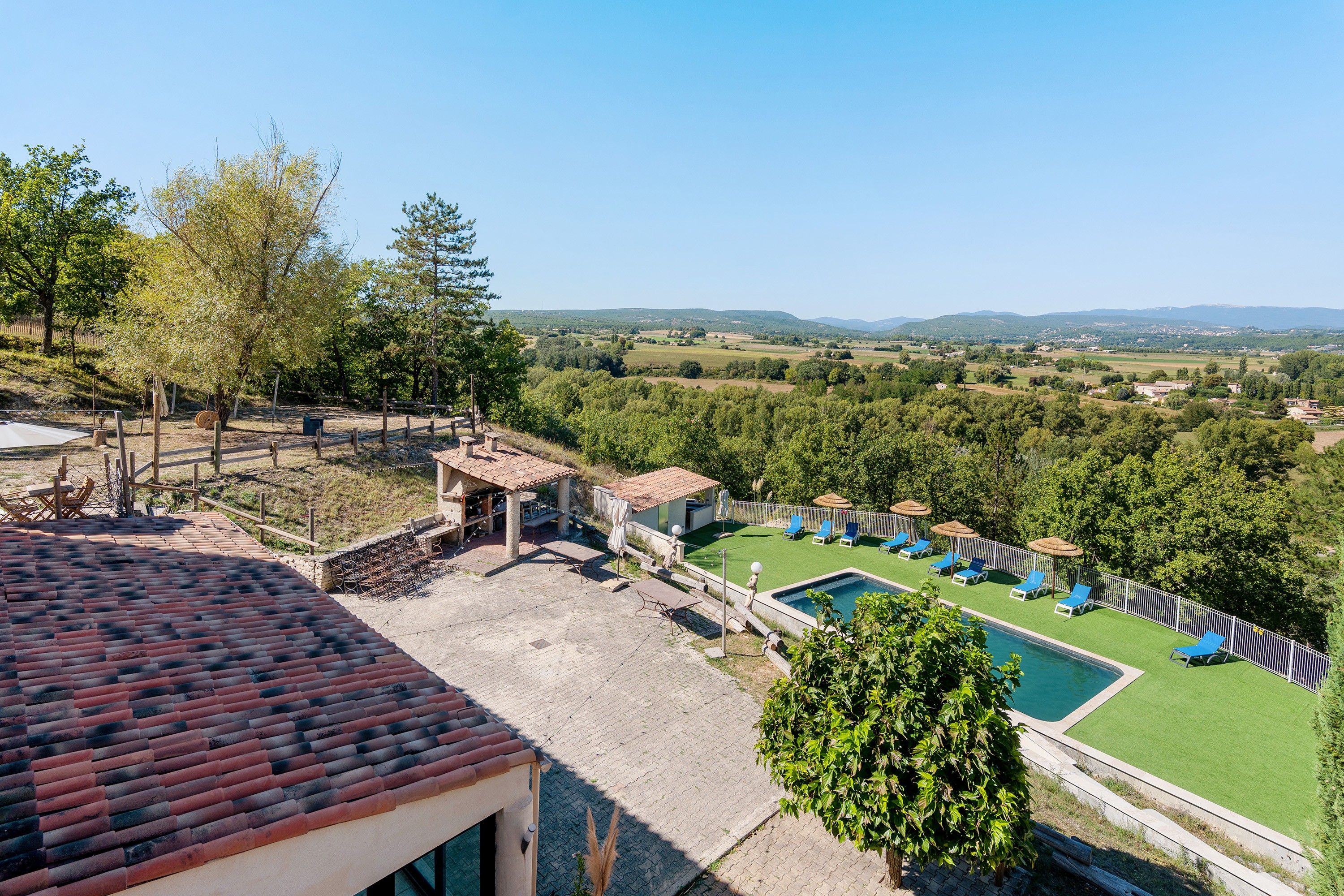 A pool area with a view of the countryside.