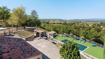 A pool area with a view of the countryside.