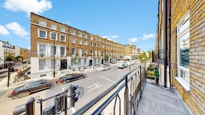 A street view with a row of terraced houses, a bicycle lane, and a pedestrian crossing. - Gloucester Place (London)