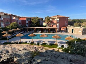 A resort with multiple swimming pools, lounge chairs, and umbrellas. - Hôtel Maristella (Aregno)