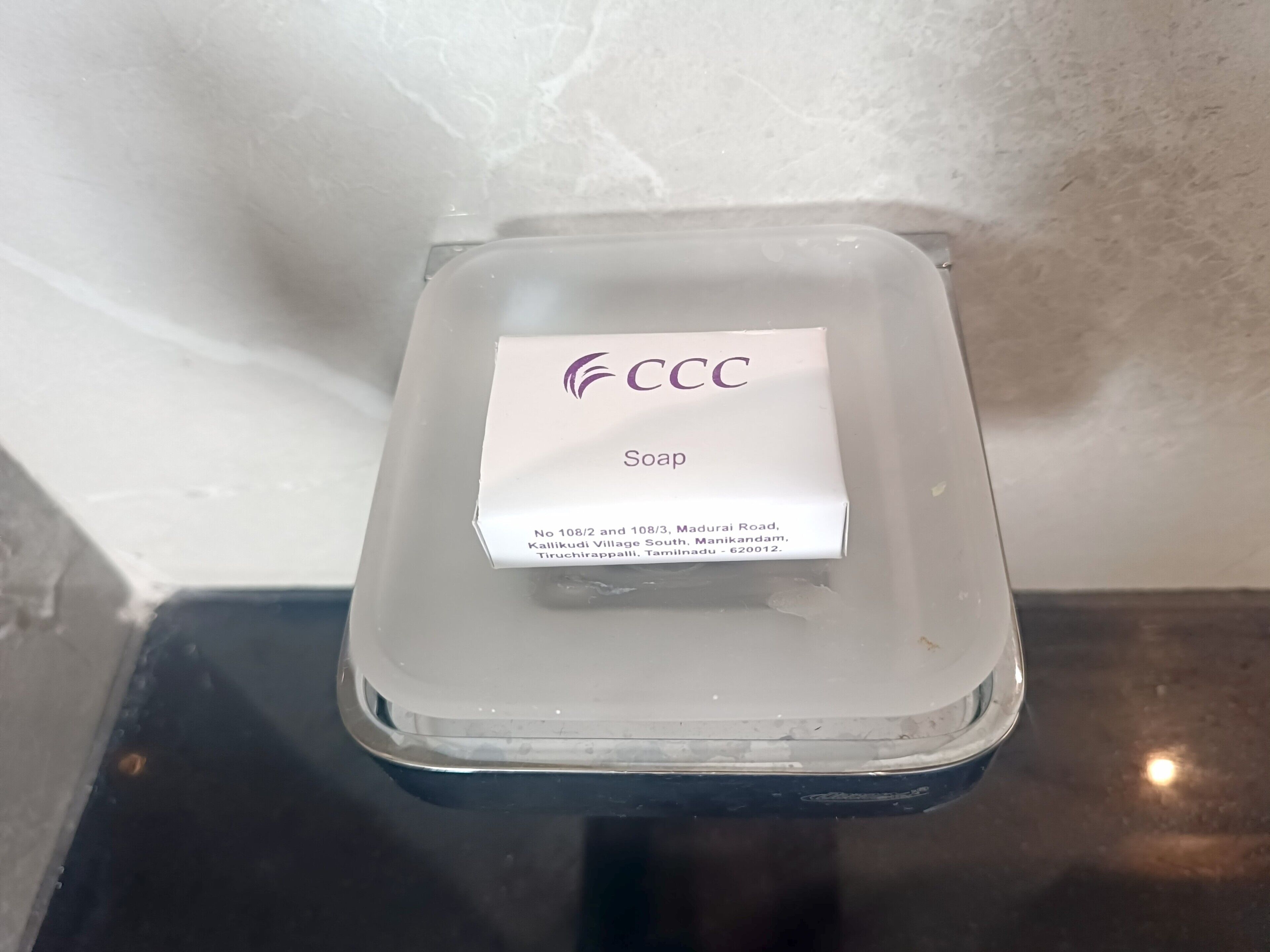 A soap box with a label on a reflective surface.