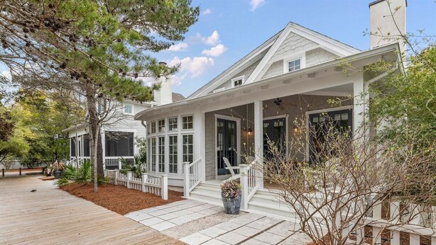 A two-story house with a covered porch, a wooden deck, and a landscaped garden. - Watersound Resort, Coastal Charm, Walk To Beach! (Inlet Beach)