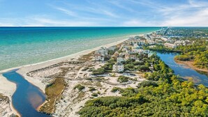 An aerial view of a coastal area with a beach, a river, and a cluster of buildings. - Watersound Resort, Coastal Charm, Walk To Beach! (Inlet Beach)