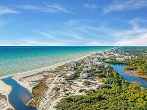 An aerial view of a coastal area with a beach, a river, and a cluster of buildings. - Watersound Resort, Coastal Charm, Walk To Beach! (Inlet Beach)