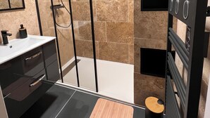 Ein modernes Badezimmer mit Dusche, Waschbecken und Toilette.