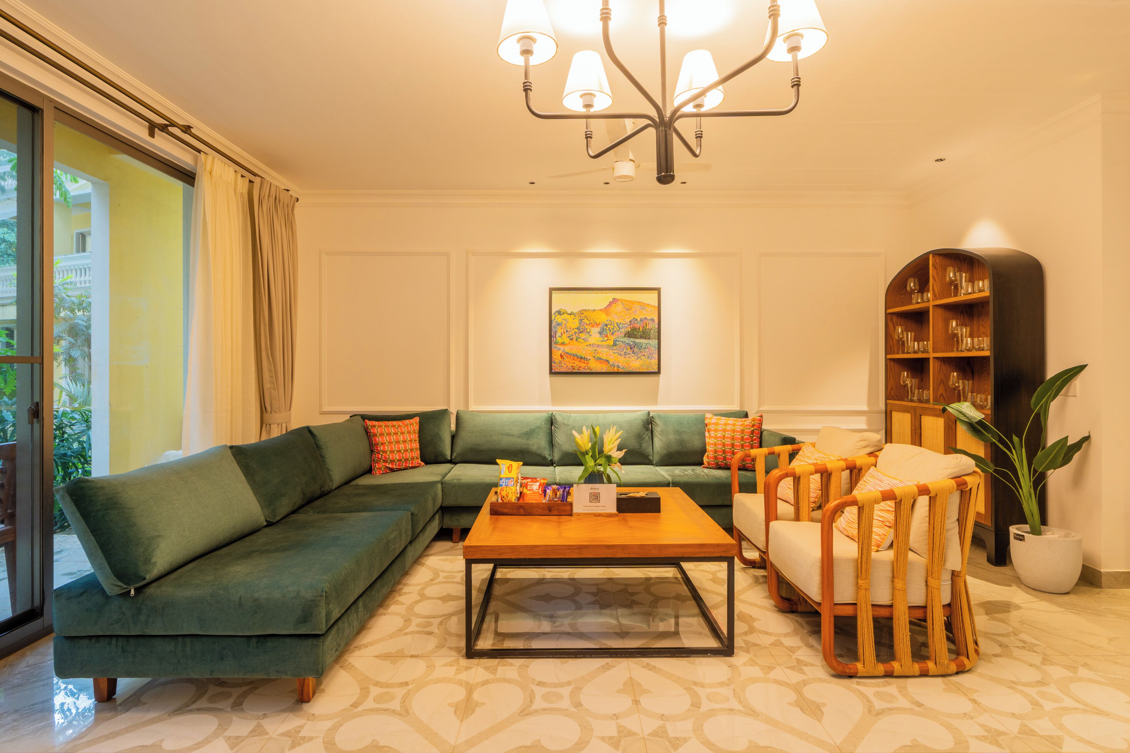 A living room with a green sofa, a wooden coffee table, and a bookshelf.