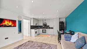 A modern apartment with a kitchen, dining area, and living room. - 31A|Stylish Kingswood Retreat for Couples & Pros (Kingswood)