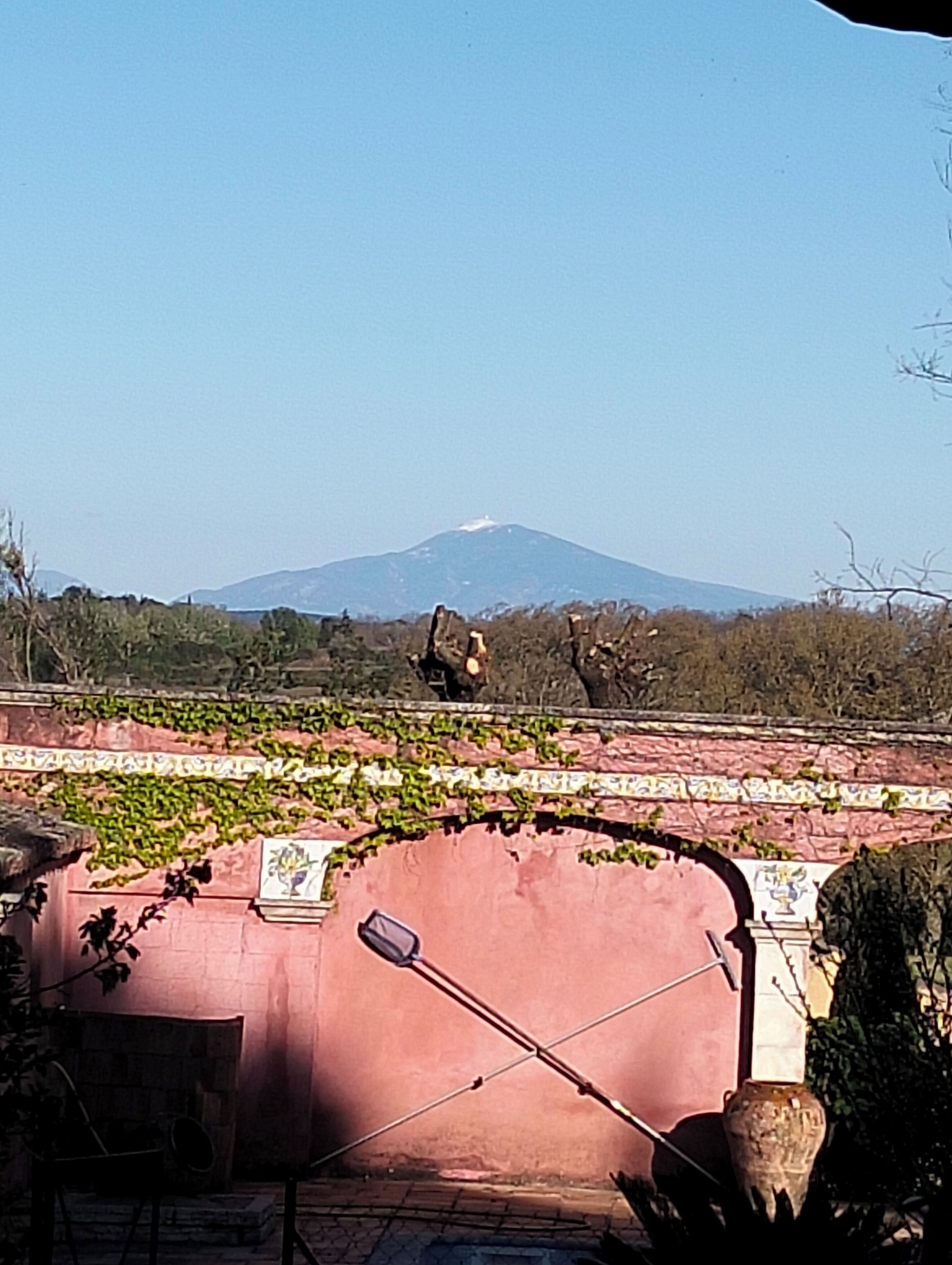 A view of a mountain with a clear sky.