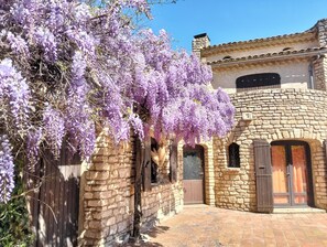 A stone building with a wooden door and a window. - Provencal family home  (Saint-Paulet-de-Caisson)