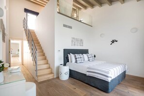 A bedroom with a bed, a staircase, and a view of the outdoors. - Villa Karga (4 bedroom villa) (Almyrida)