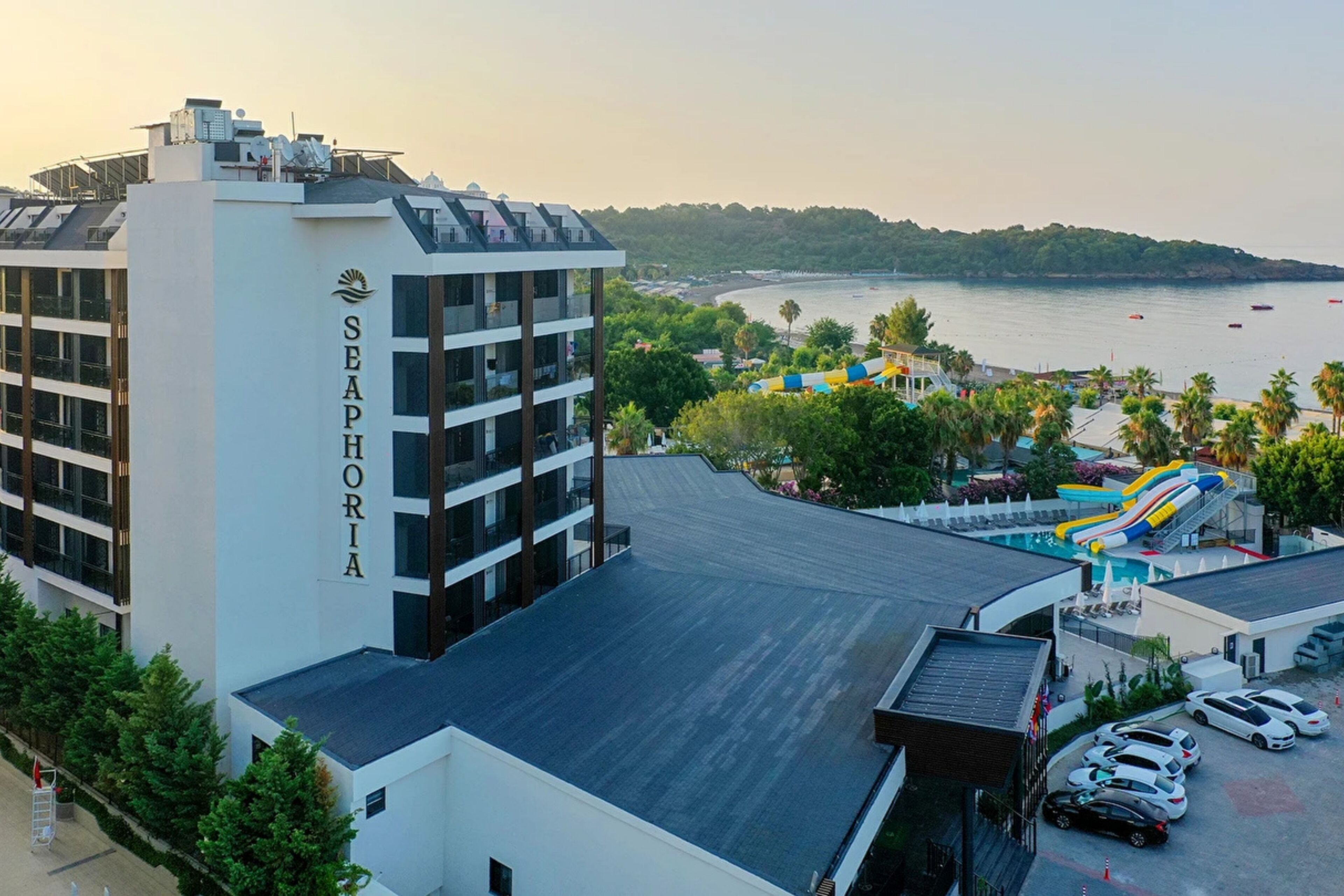 A modern hotel with a rooftop pool, a beach view, and a sign reading 'SEAPHORIA'.