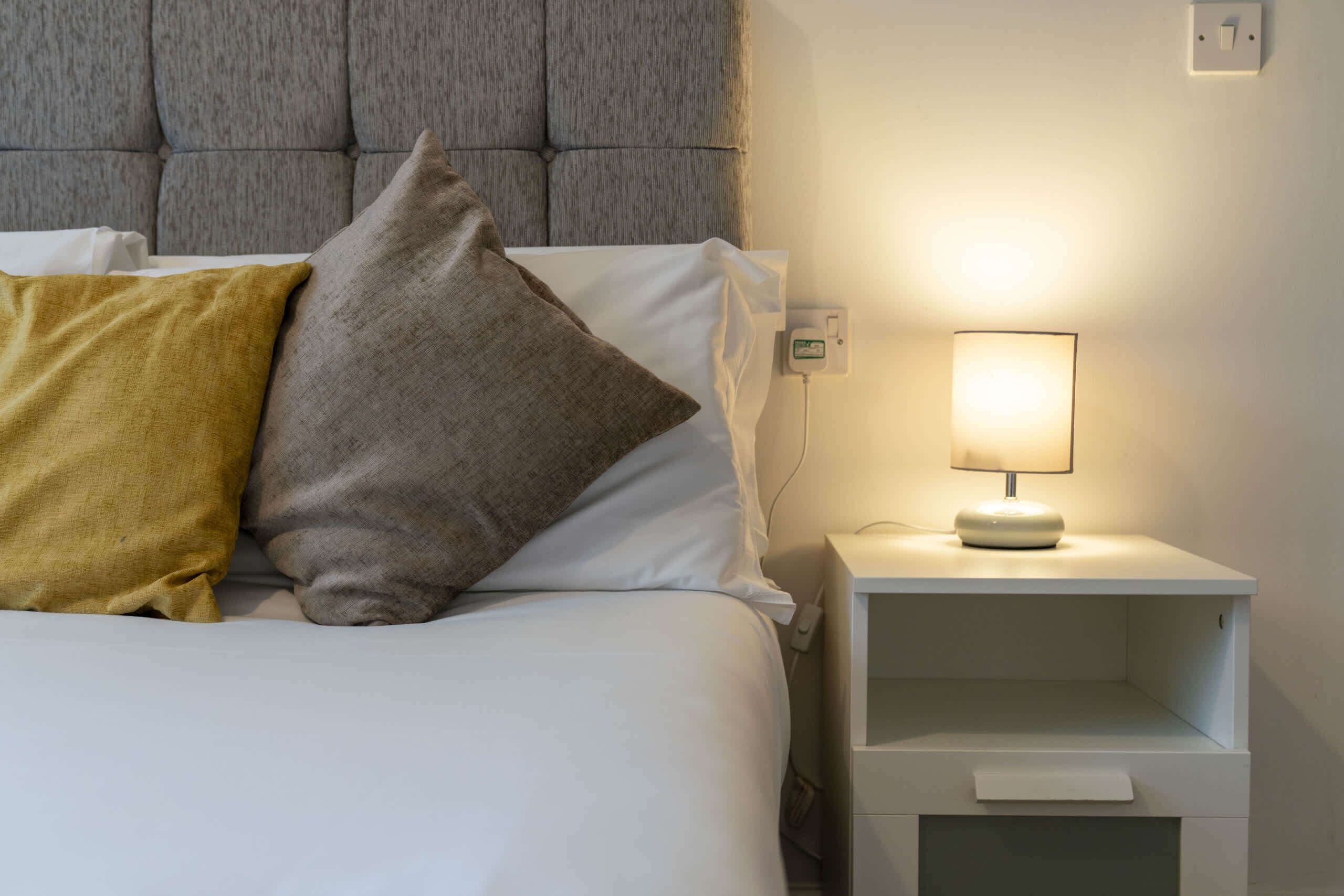 Bedroom: A chic retreat featuring plush cushions and a warm bedside glow for tranquil nights.