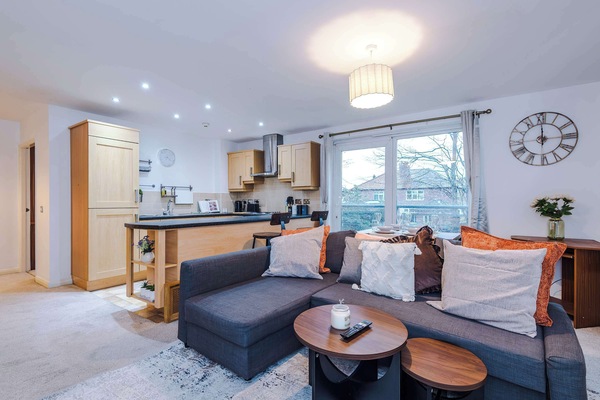 Living Room: Bright, airy space with a stylish sofa and scenic balcony views!